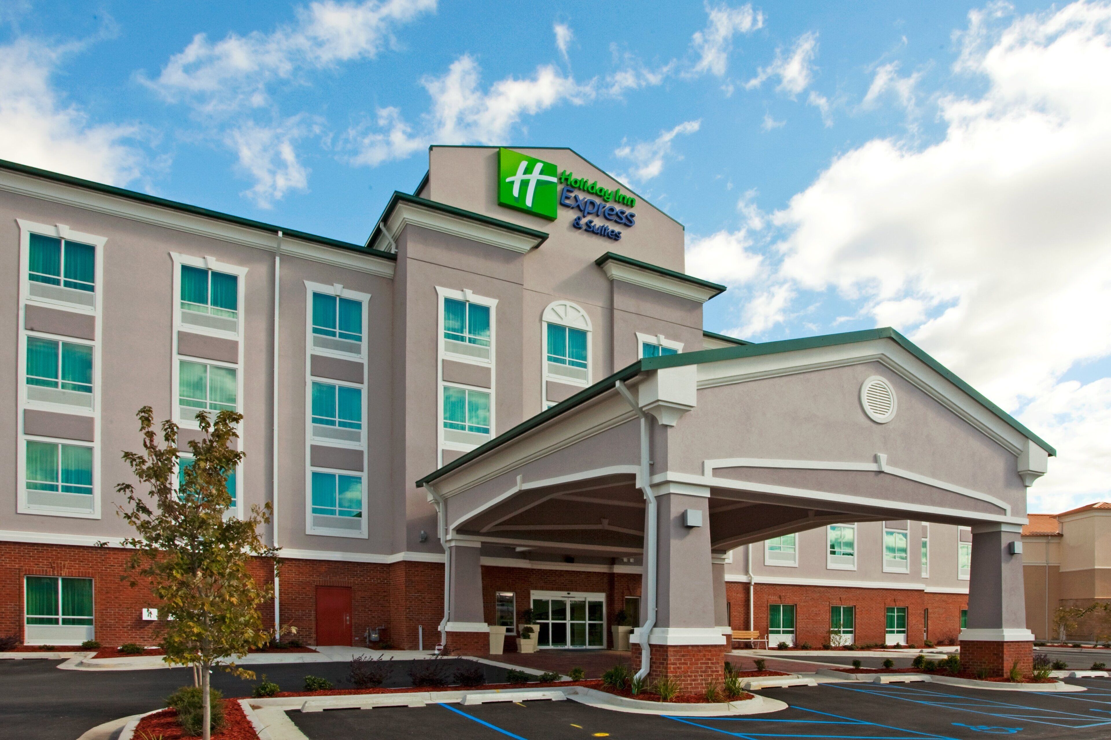 A Holiday Inn Express hotel with a brick facade, large windows, and a covered entrance.