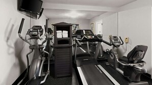 A gym with treadmills, elliptical machines, and a TV mounted on the wall. - Best Western Executive Inn (Grove City)