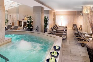 A spa area with a hot tub, lounge chairs, and a massage table. - Crowne Plaza Rome-St. Peter's Hotel & Spa by IHG (Rome)