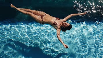 A person swimming in a pool.