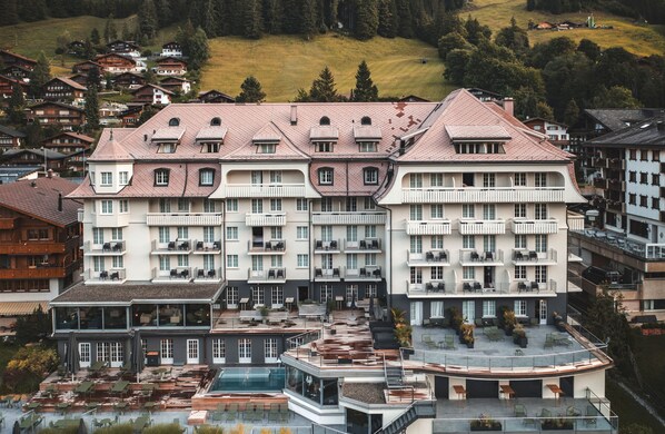 Experience the charm of traditional European architecture at this hotel, featuring a symmetrical facade with balconies and a rooftop pool.