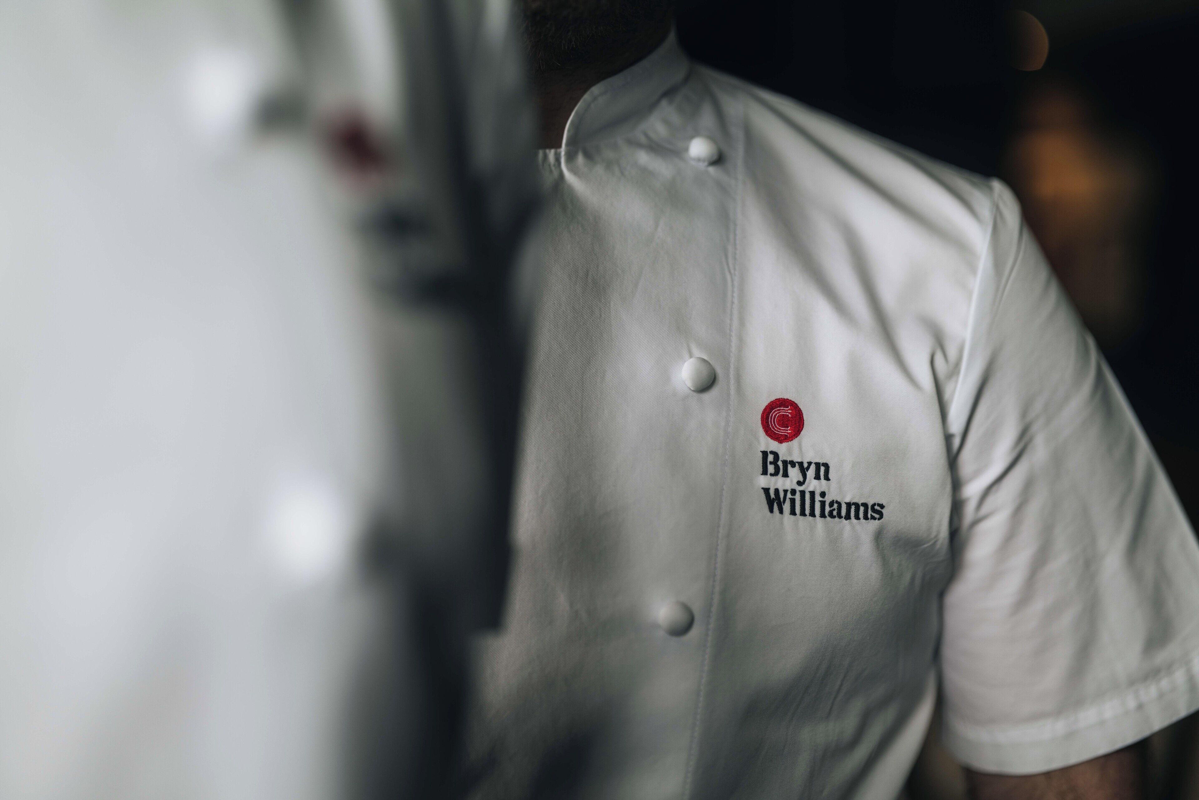 A chef's uniform with the name "Bryan Williams" and a logo on the chest.