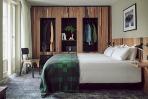 Relax in this inviting space with a large bed, a comfortable chair, and a desk for work.