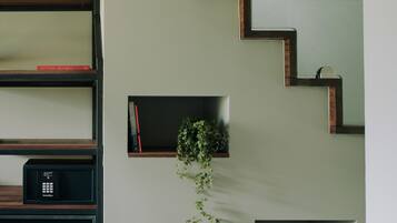 Ein modernes Interieur mit Treppe, Einbauschränken und einer kleinen Pflanze.