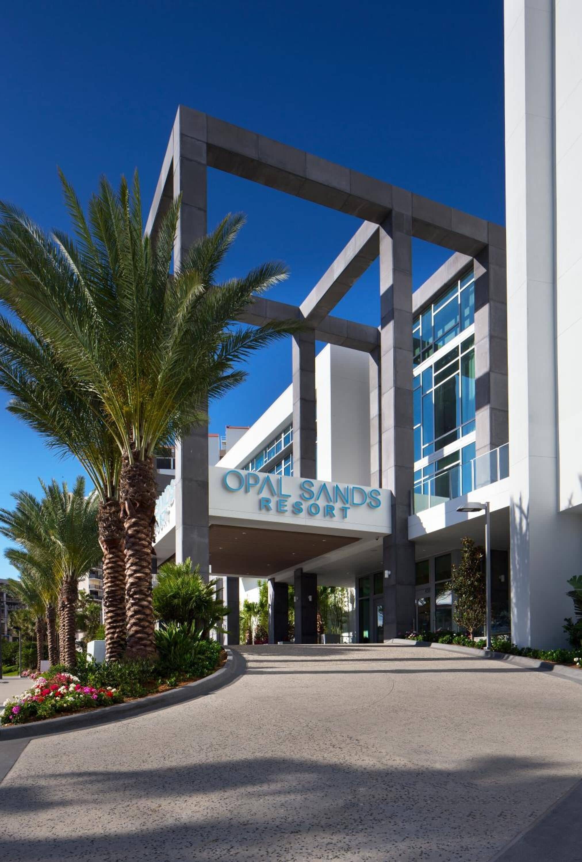 Un edificio moderno con un cartello che riporta la scritta "OPAL SANDS RESORT".