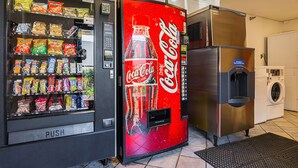 A vending machine with snacks and a Coca-Cola dispenser. - Motel 6 Tucker, GA - Atlanta Northeast (Tucker)