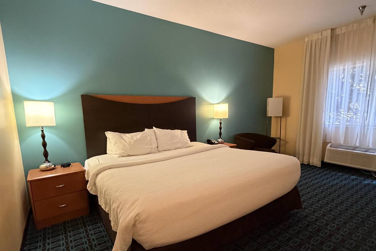 Premium bedding, desk, laptop workspace, blackout drapes