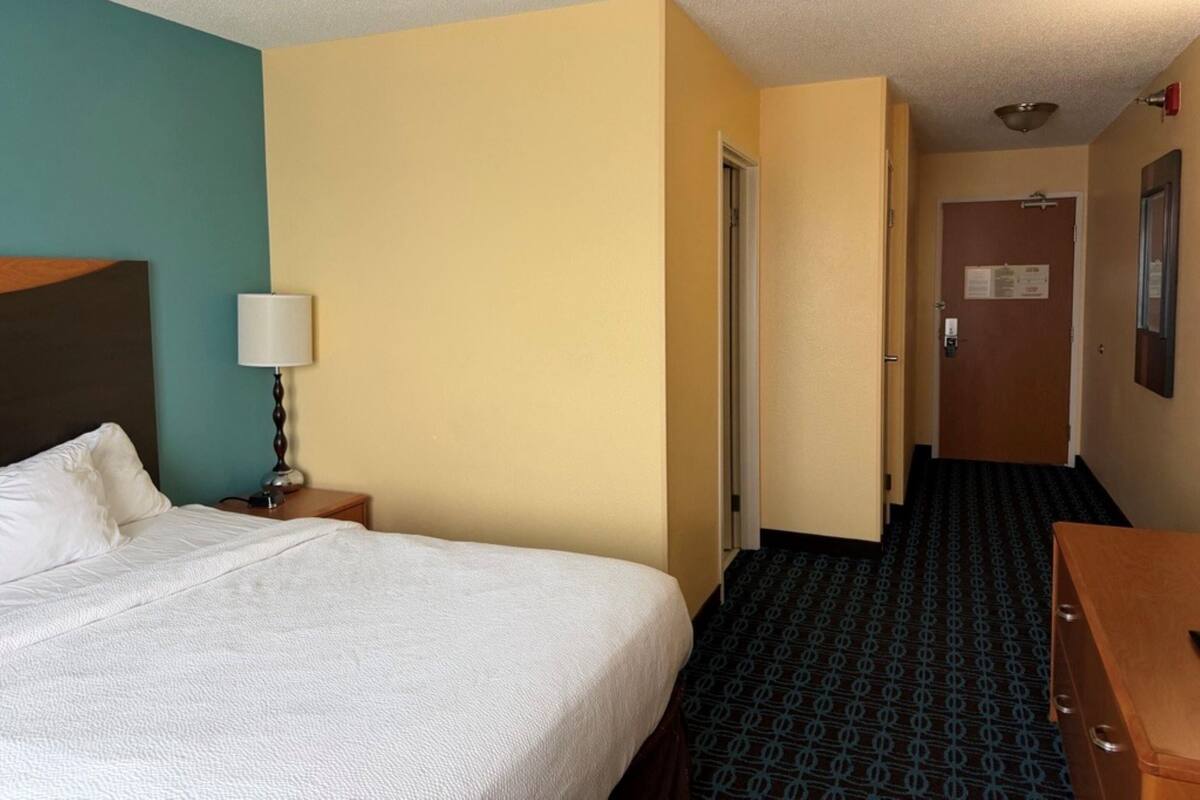 Premium bedding, desk, laptop workspace, blackout drapes