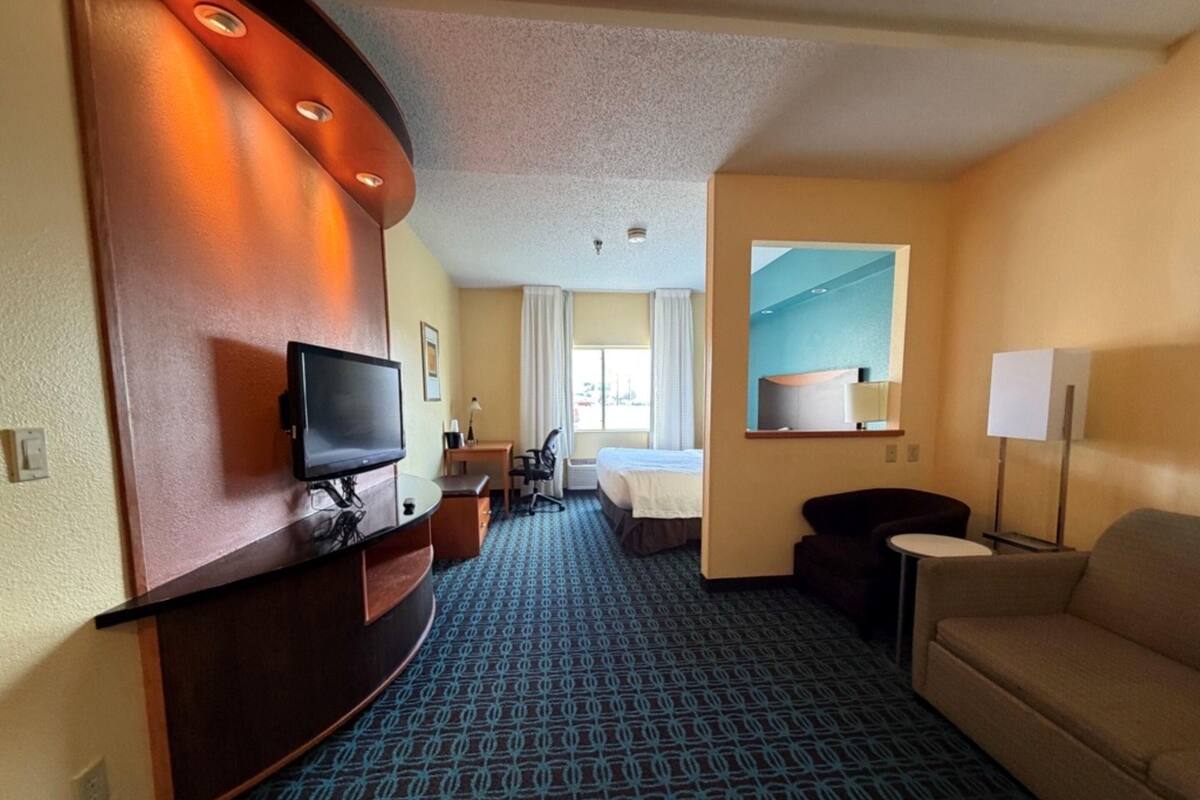 Premium bedding, desk, laptop workspace, blackout drapes