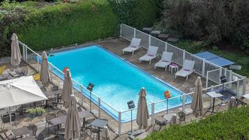 Seasonal outdoor pool, open 9:00 AM to 8:00 PM, pool umbrellas