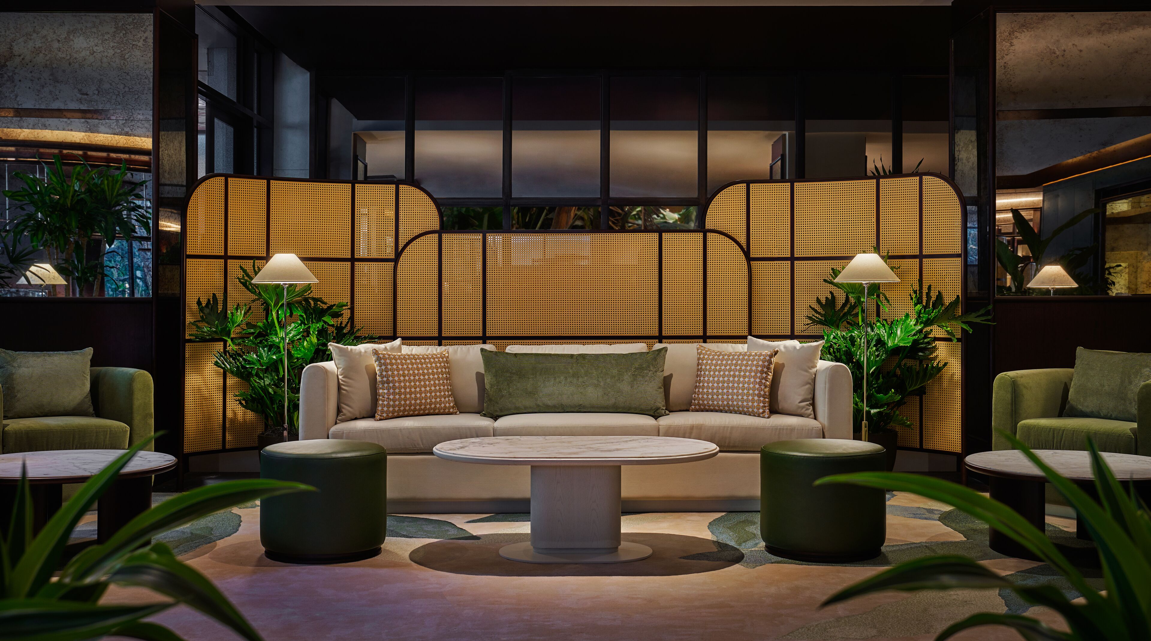 A modern lounge area with a sofa, two side tables, and a coffee table.