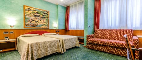 A hotel room with two beds, a sofa, a painting on the wall, and a window with curtains.