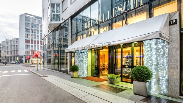 A hotel with a modern facade, large windows, and a marquee sign. - Hotel Brunelleschi (Milan)