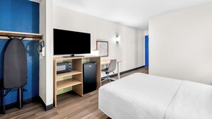 A hotel room with a bed, a desk with a computer, a television, and a chair. - Spark by Hilton Roanoke Civic Center (Roanoke)