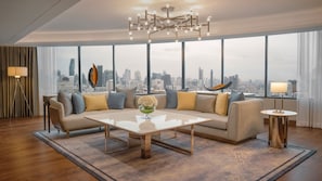 A modern living room with a city view, a sofa set, a coffee table, and a chandelier. - InterContinental Bangkok by IHG (Bangkok)