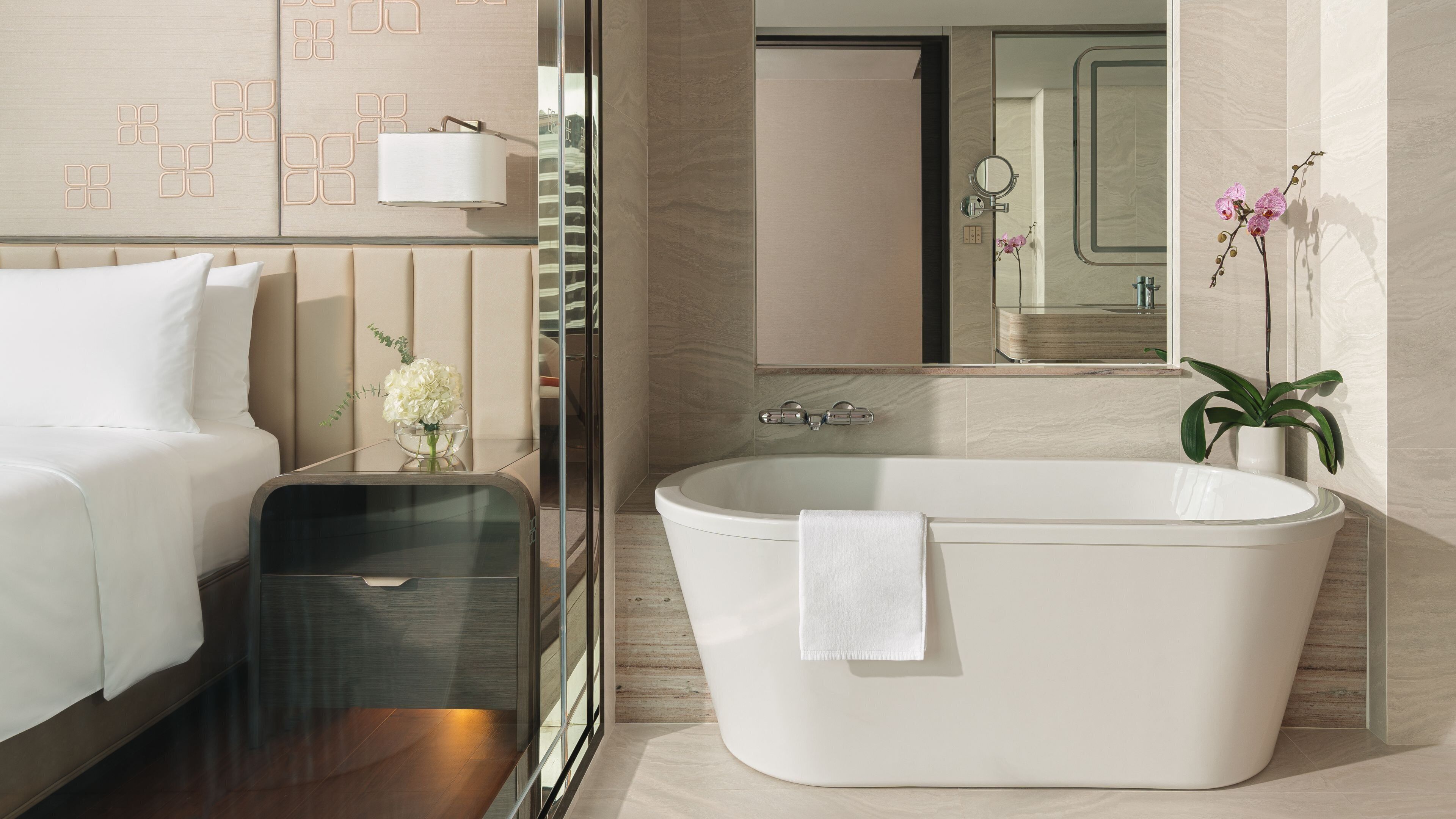 A modern bathroom with a freestanding bathtub, a glass shower enclosure, and a mirror above the sink.