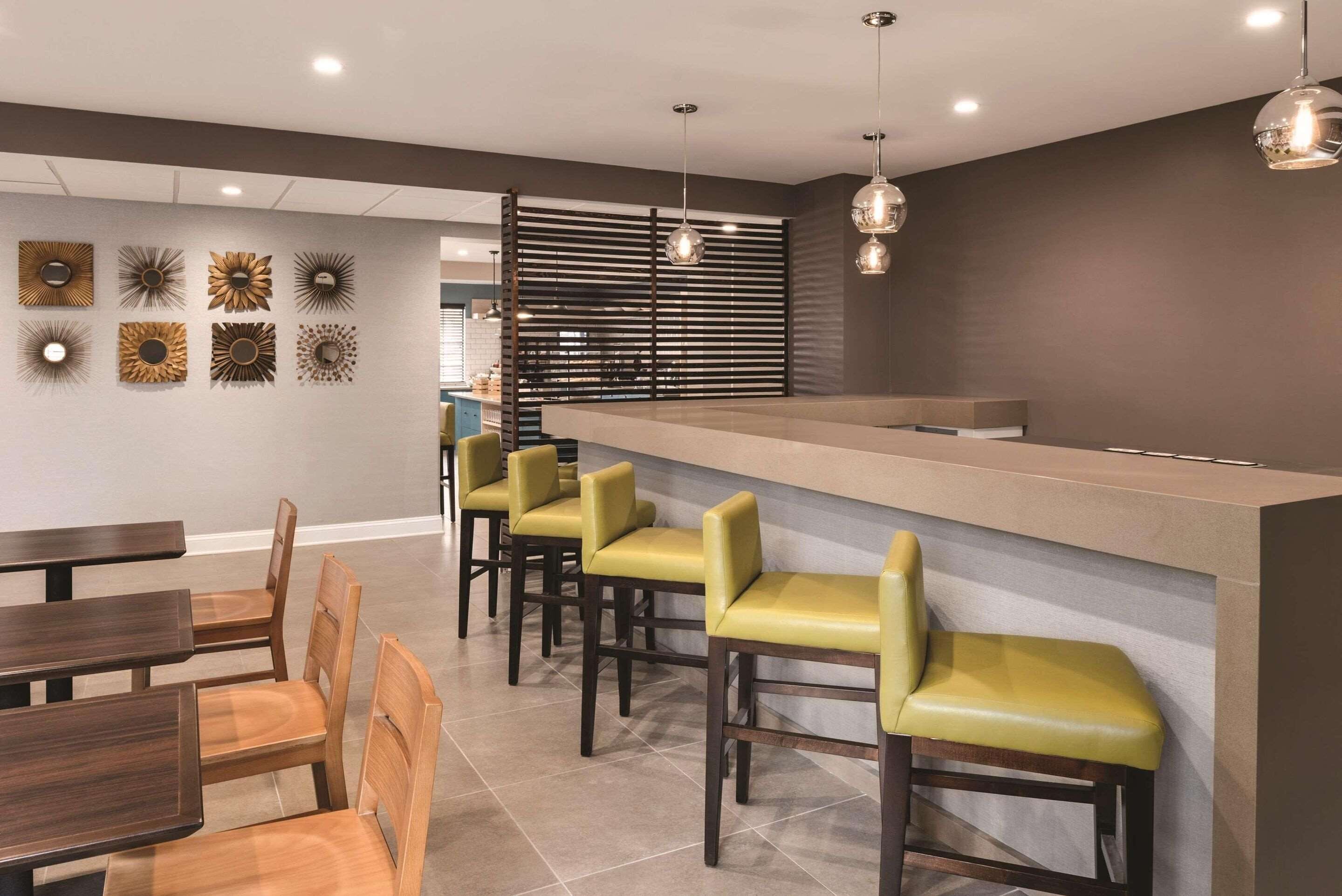 Un área de bar moderna con sillas de madera y una barra.