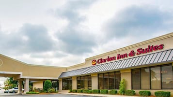 Welcome to Clarion Inn & Suites, featuring a modern exterior with large windows and a covered entrance.