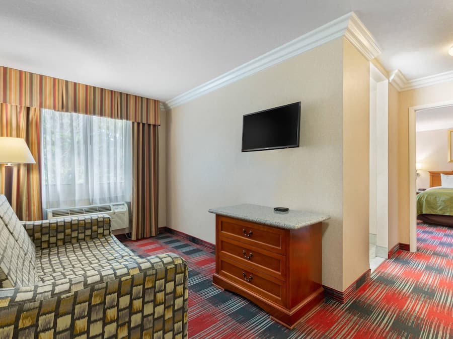 Desk, laptop workspace, blackout drapes, iron/ironing board