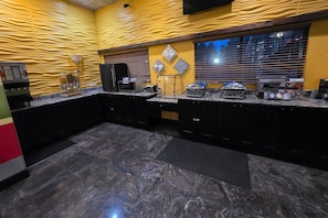 A modern kitchen with granite countertops, a microwave, a toaster, and a coffee maker. - Quality Inn Cairo (Cairo)