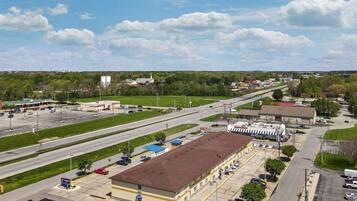 A large industrial building with a flat roof and a parking lot.