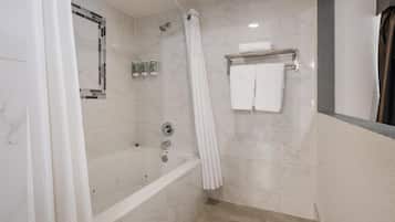 A modern bathroom with a bathtub, a shower curtain, and a towel rack.