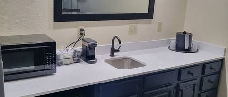 A modern kitchen with a built-in microwave, sink, and dishwasher.