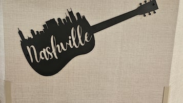 A guitar-shaped sign with the word 'Nashville' on it.