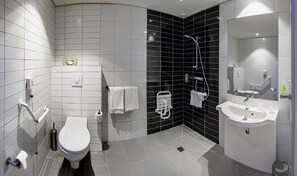 A modern bathroom with a toilet, sink, and shower.