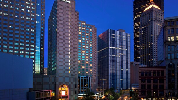 A cityscape with high-rise buildings, including a prominent Westin hotel. - The Westin Pittsburgh, a Marriott Hotel (Pittsburgh)