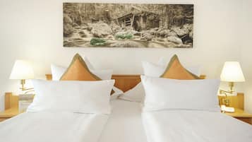 A hotel room with a bed, two nightstands, a wall-mounted painting, and two lamps.