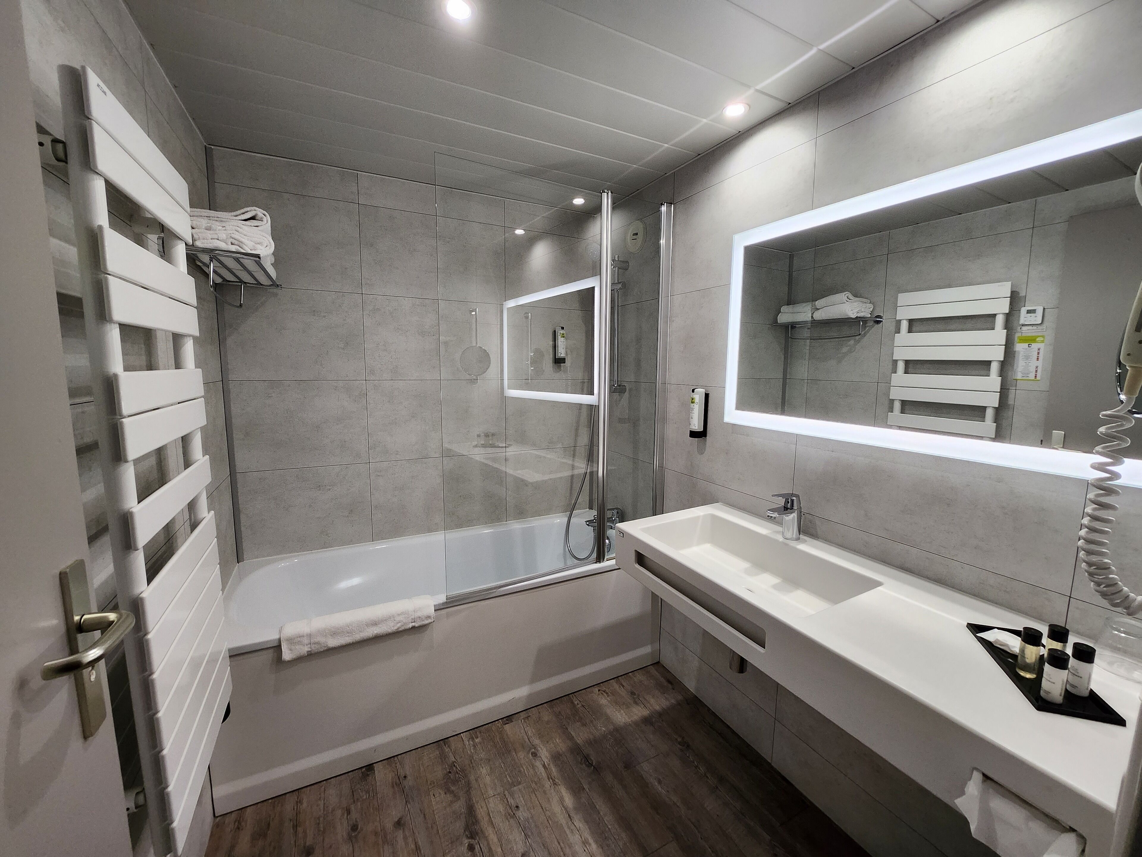 bathtub, hair dryer, towels, soap