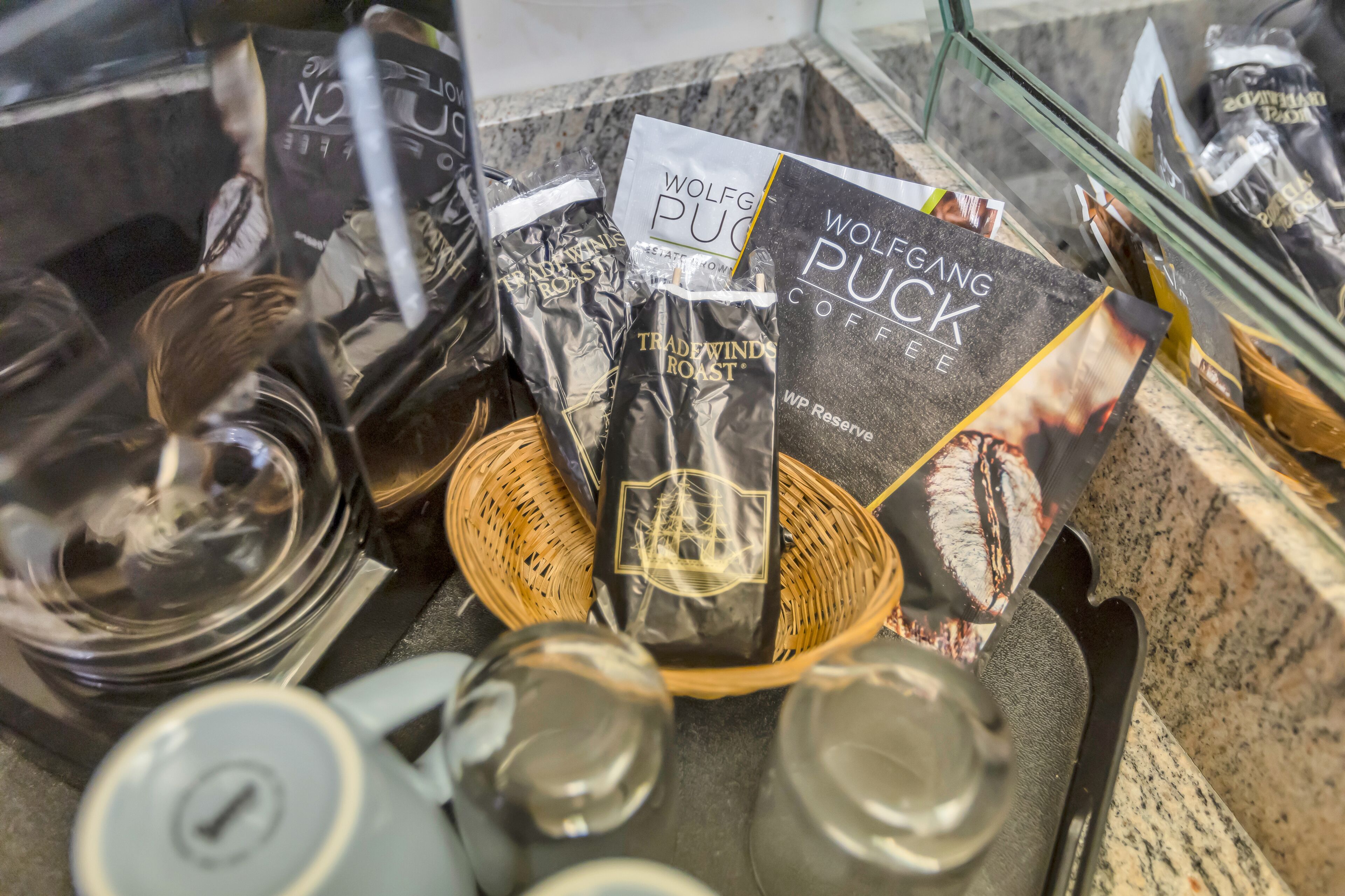 A coffee display with bags of coffee and a teapot.