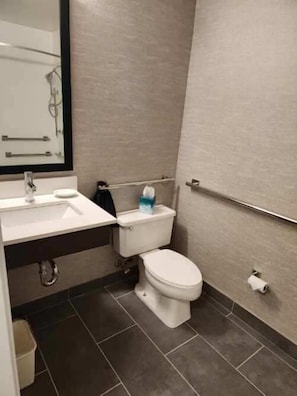 Bathroom features a sink, toilet, and towel rack.