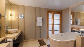 A modern bathroom with a freestanding bathtub, a vanity with a sink, a mirror, and a towel rack.