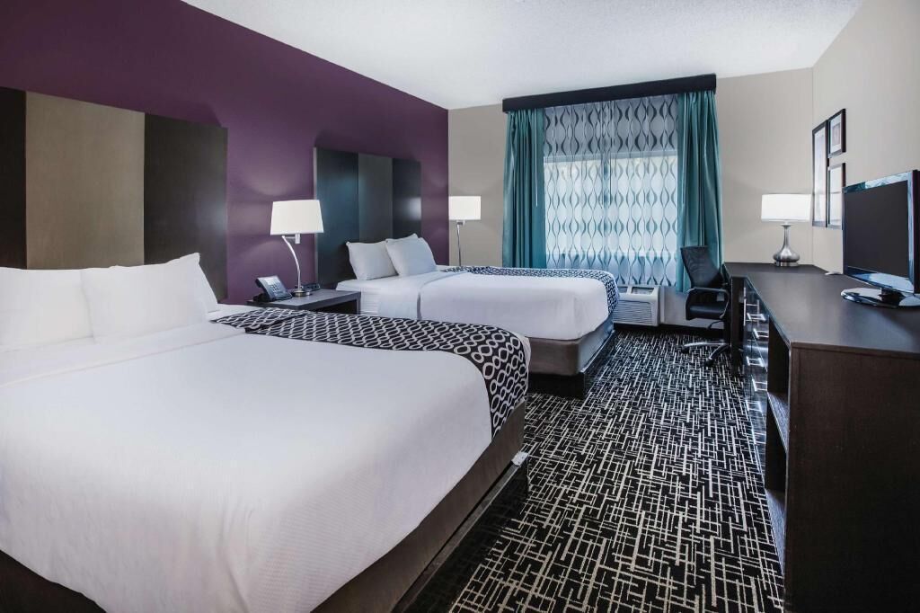 Premium bedding, desk, laptop workspace, blackout drapes