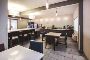 Relax in a spacious room with a large bed, bedside table, and comfortable seating area.