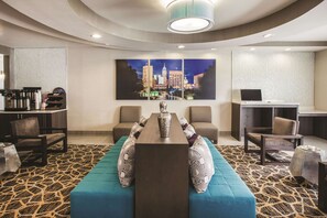 Relax in a stylish room with a seating area, desk, and cityscape artwork.