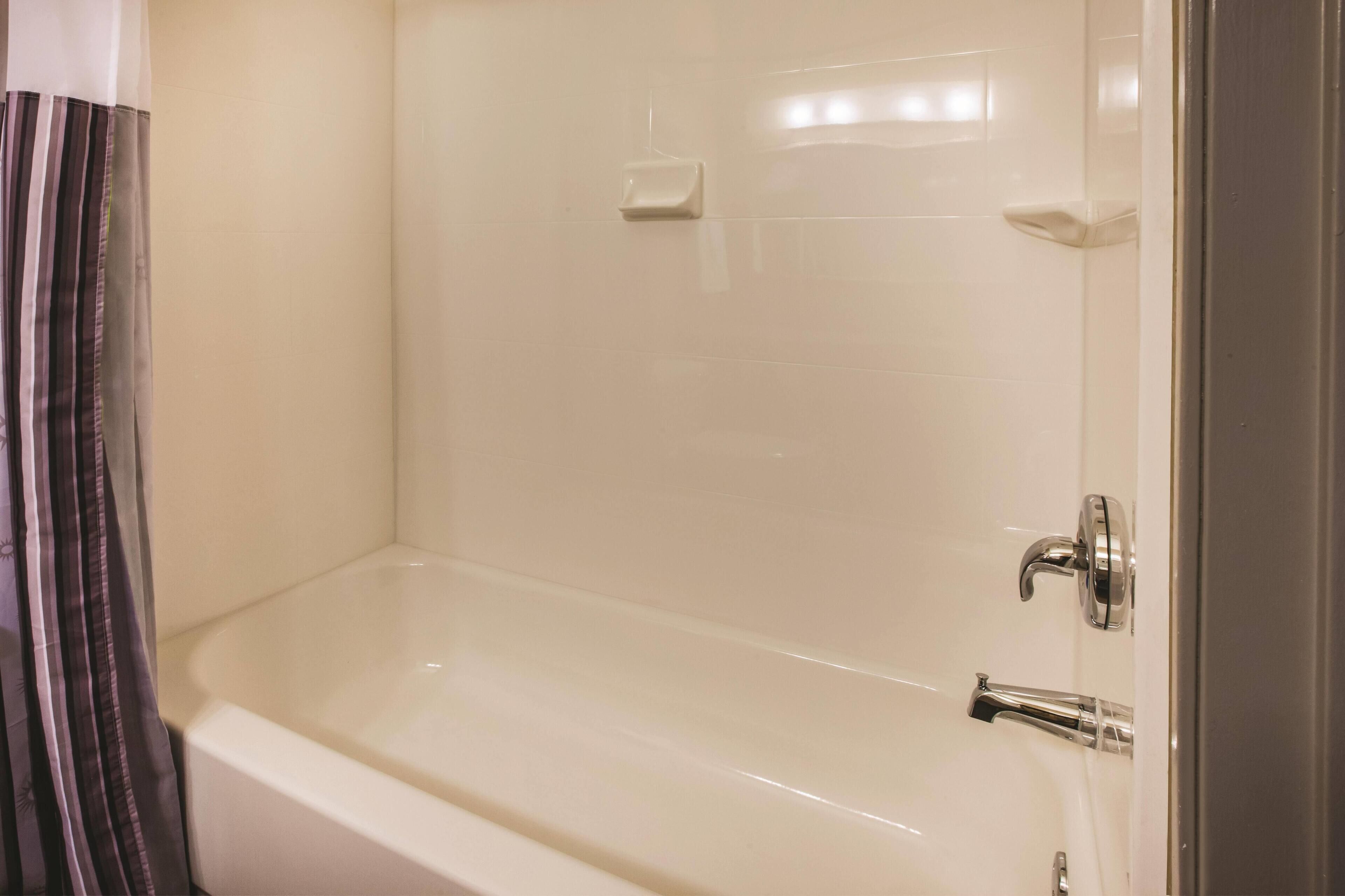 A bathroom with a bathtub, a shower, and a toilet.