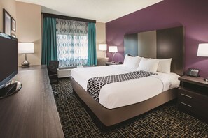 Relax in a stylish room with a large bed, flat-screen TV, and desk area.