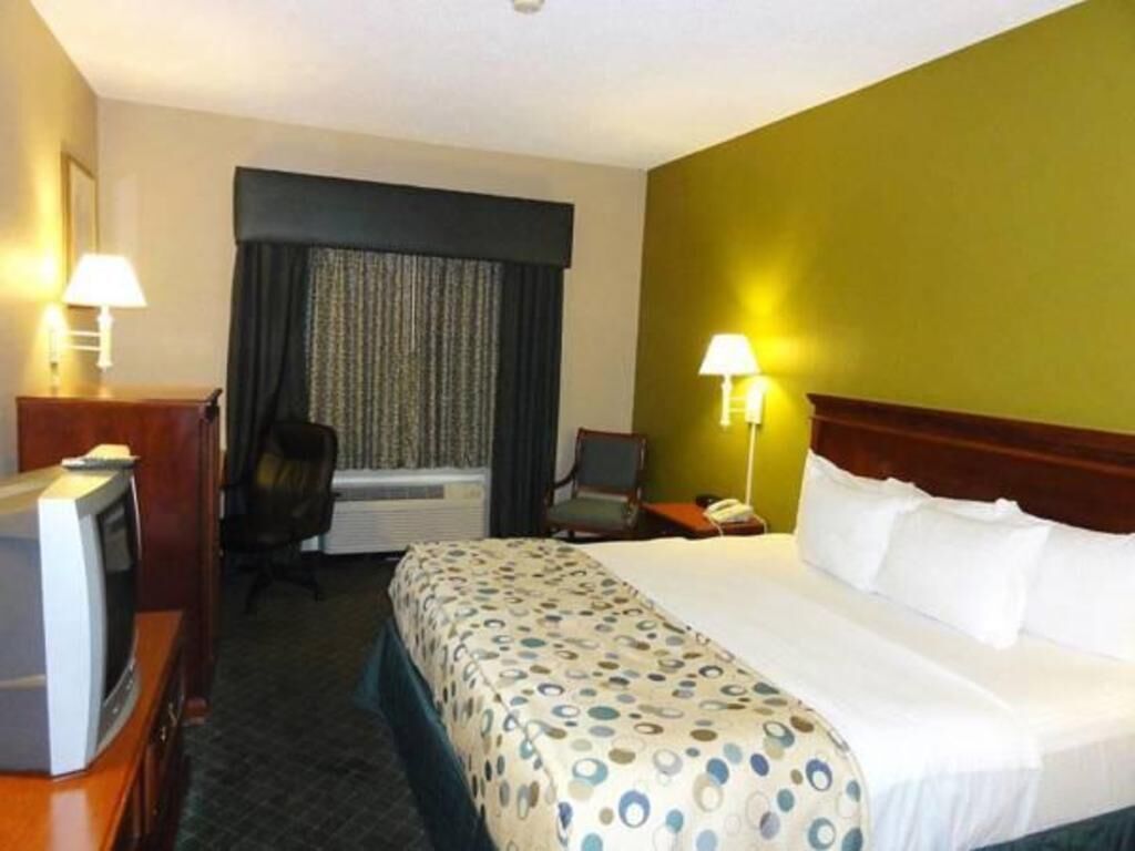 Premium bedding, desk, laptop workspace, blackout drapes