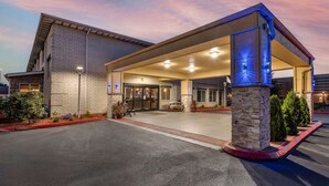 A hotel entrance with a covered outdoor area, a brick facade, and a landscaped entrance. - Comfort Inn Kelso - Longview (Kelso)