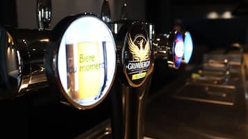 A row of beer taps with labels, including one for 'Grimbergen Blonde'.