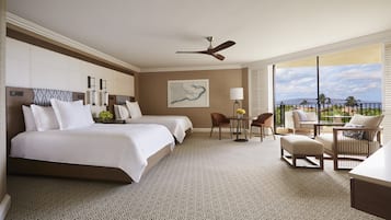 A hotel room with two beds, a dining area with chairs, a table, a ceiling fan, and a large window with a view.