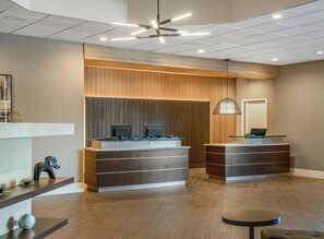 A reception area with two counters, a ceiling fan, and a hanging pendant light.