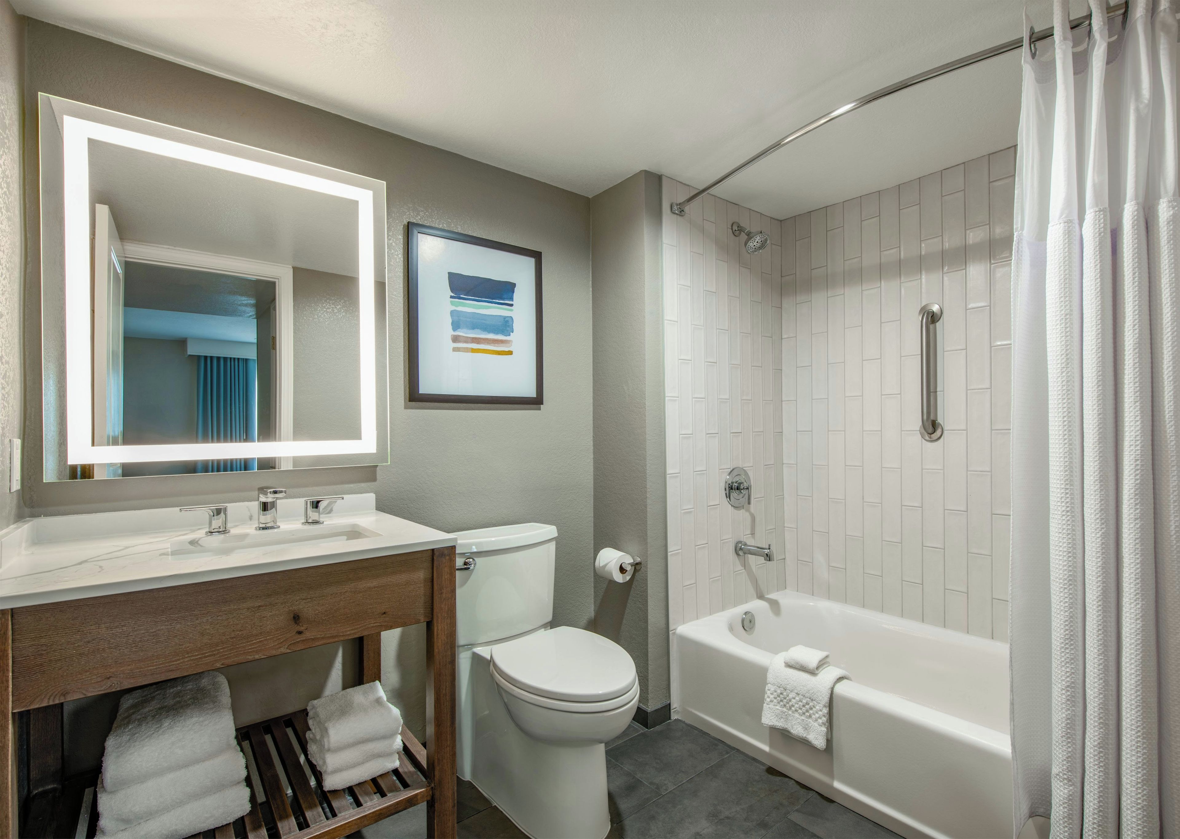 A bathroom with a sink, toilet, bathtub, and shower.