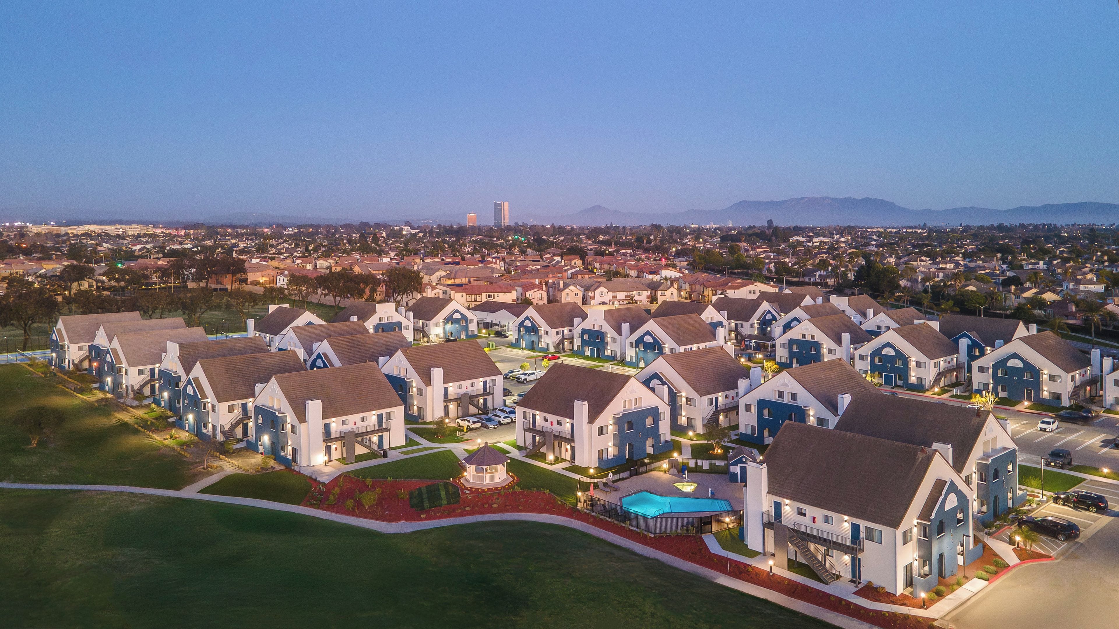 A residential area with multiple two-story houses, a swimming pool, and a gazebo.