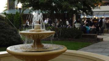 A multi-tiered fountain with water jets in an outdoor setting.