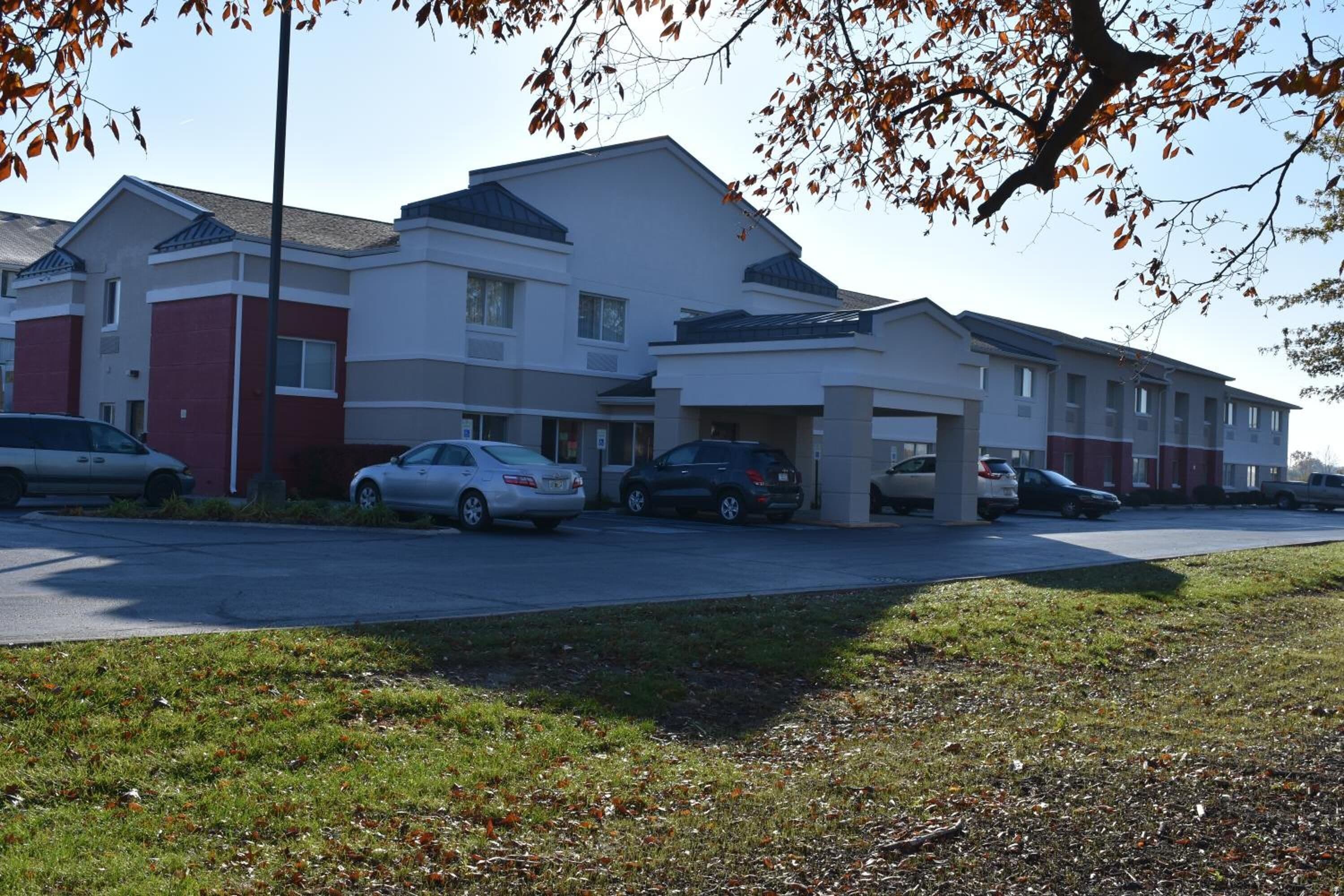 A multi-story residential building with a parking lot.