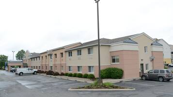 A multi-story hotel with a parking lot.